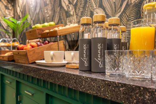 a counter with bottles and glasses of orange juice at Lennox Buenos Aires in Buenos Aires