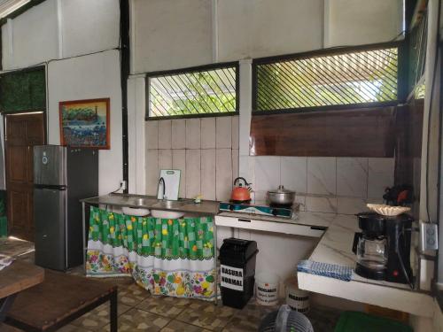a kitchen with a sink and a stove in it at Casa Concha Golfito in Golfito