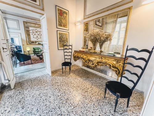 a living room with two chairs and a fireplace at Luxury Apartment in Lucca in Lucca