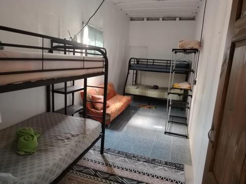 a small room with two bunk beds and a hallway at Casa Concha Golfito in Golfito