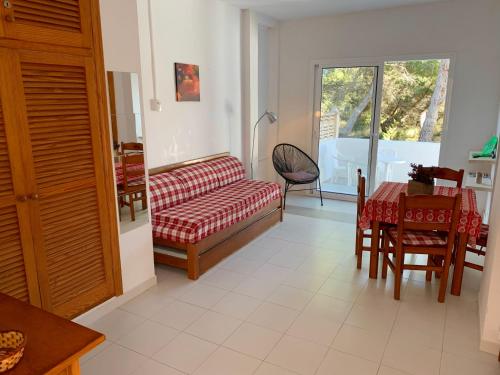 a living room with a couch and a table at Apartamentos, Edificio Pujolets Es Pujols-Playa in Es Pujols