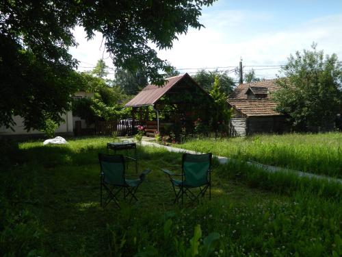 two chairs sitting in the grass in a yard at Vendel Guesthouse in Mereni
