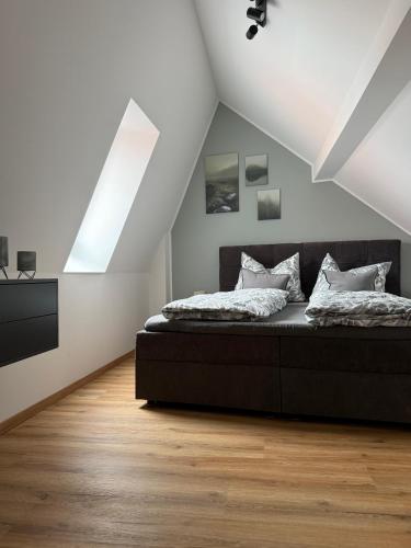 a bedroom with a bed in a attic at Dachblick by Zirwick Apartment in Windischeschenbach