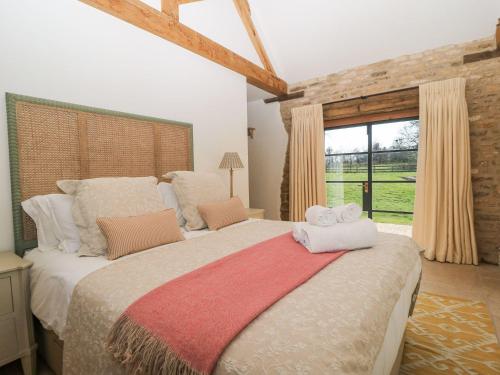 a bedroom with a large bed with towels on it at The Forge in Stow on the Wold
