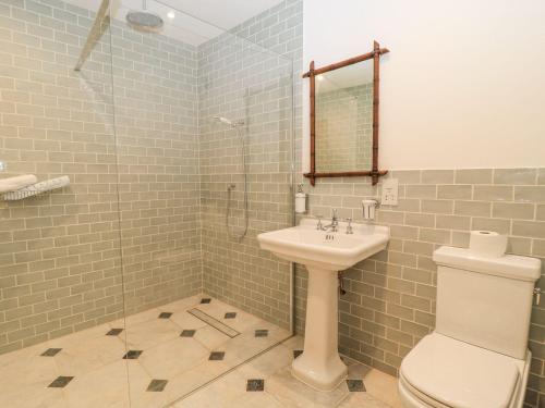 a bathroom with a sink and a toilet and a shower at The Forge in Stow on the Wold