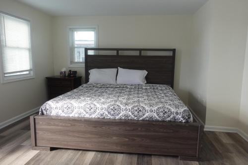 a bedroom with a large bed with a wooden headboard at Freedom INN Motel in Grantville