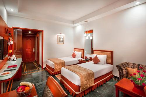 Postel nebo postele na pokoji v ubytování Regency Madurai by GRT Hotels