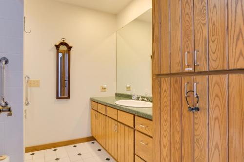 a bathroom with a sink and a mirror at Lake Access w/ Dock! Hayward Cabin Hideaway in Hayward