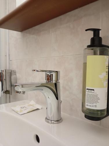 a soap dispenser sitting on top of a sink at Il Leone D'Oro in Telgate