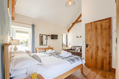 a bedroom with a large white bed and a window at 3 Bed in Llanrwst oc-bow155 in Llanrwst