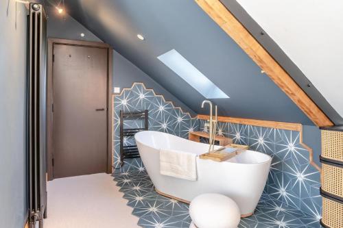 a bathroom with a bath tub in a attic at 5 Bed in Bwlch oc-p32273 in Bwlch