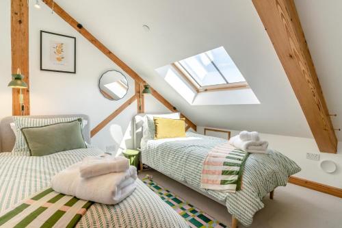 a attic room with two beds and a window at 5 Bed in Bwlch oc-p32273 in Bwlch