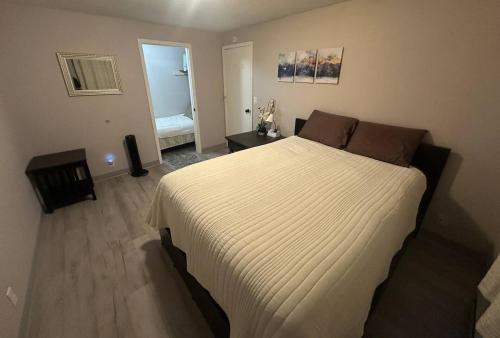 a bedroom with a large white bed in a room at Homestake Haven in Lead