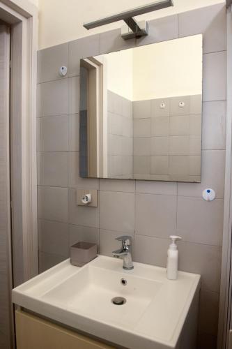 a bathroom with a sink and a mirror at ASARO Camere in Campobello di Licata