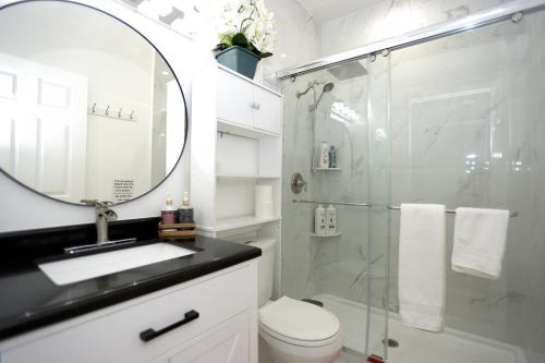 a bathroom with a shower and a toilet and a sink at Spacious and Brand New Apartment in Point Breeze - Prime Location in Philadelphia