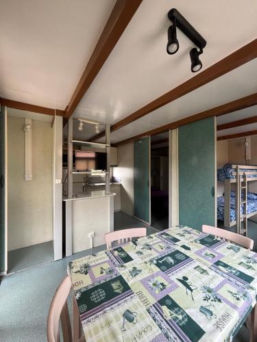 a dining room with a table and a kitchen at Camping Deva in Deva