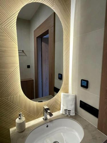 a bathroom with a sink and a mirror at Apartamenty Skalny Loft in Karpacz