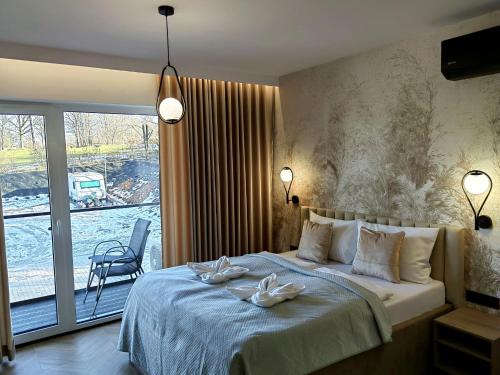 a bedroom with a bed with two towels on it at Apartamenty Skalny Loft in Karpacz