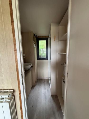 a small bathroom with a toilet and a window at Camping Deva in Deva