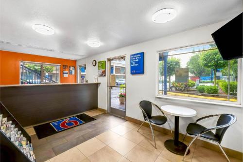 a waiting room with a table and chairs in a store at Motel 6 - Motel 6 Portland, OR - Downtown in Portland