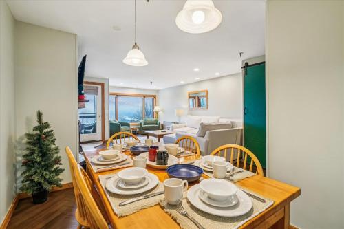 a dining room with a table and chairs with a christmas tree at Highridge B14 Enjoy the view ski back trail shuttle service sports center in Killington