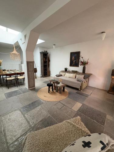 a living room with a couch and a table at Pothuis Zuid in Zandvoort