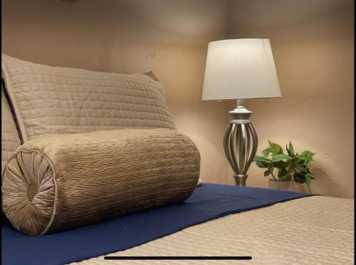 a bedroom with a bed with a lamp and a pillow at This Old Frat House Bed & Breakfast in Missoula