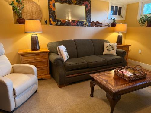 a living room with a couch and a coffee table at This Old Frat House Bed & Breakfast in Missoula