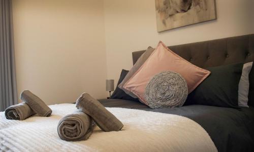 a bed with some pillows on top of it at Rook View in Buckie