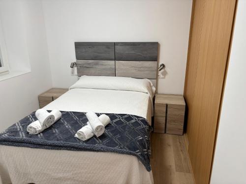 a bedroom with a bed with two pillows on it at Casa do práctico in Foz