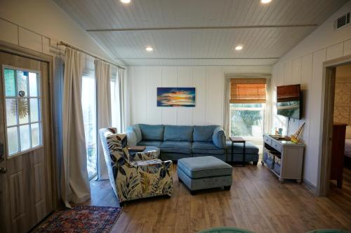 a living room with a blue couch and a table at Anna Maria Island Beach Shack Walk to Beach & Bay in Bradenton Beach