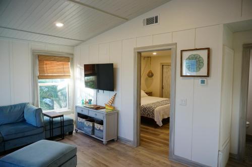 a living room with a couch and a bed at Anna Maria Island Beach Shack Walk to Beach & Bay in Bradenton Beach
