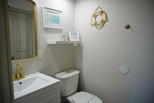 a bathroom with a white toilet and a sink at Anna Maria Island Beach Shack Walk to Beach & Bay in Bradenton Beach