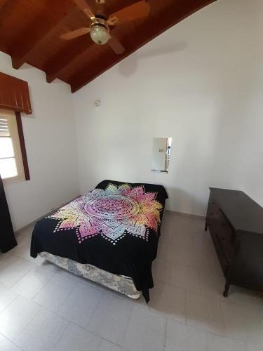 a bedroom with a bed and a dresser at Departamentos Tere in Las Grutas
