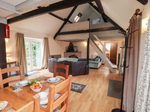 a living room with a table and a dining room at Stable Cottage in Whitby