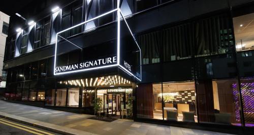 a building with a sign on the side of it at Sandman Signature Glasgow Hotel in Glasgow