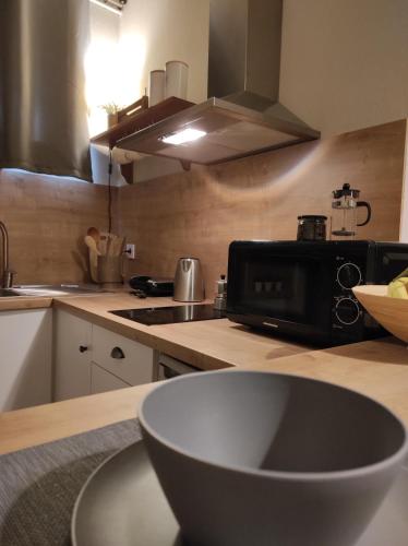 a kitchen with a counter top with a microwave at Malibu in Glyfada