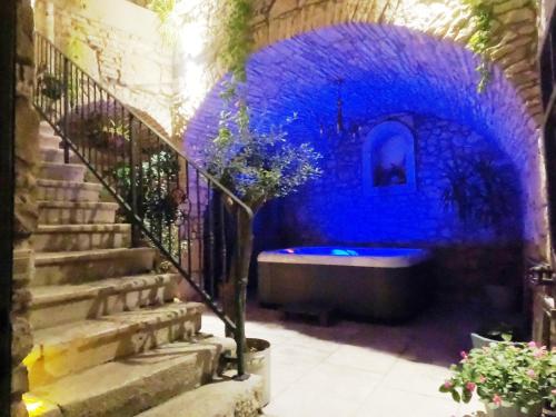 a blue room with a bath tub in a building at Stone House Hedonia in Blato