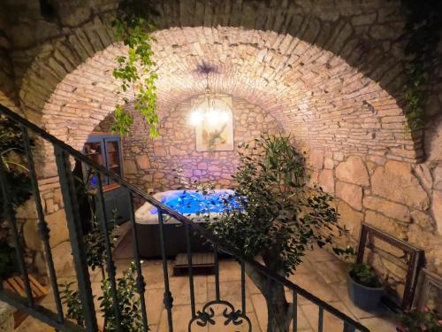 a room with a bed in a brick wall at Stone House Hedonia in Blato