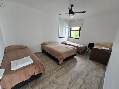 a small room with two beds and a window at Lago Santa Ana in Santa Ana