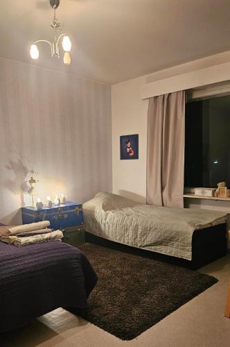 a bedroom with two beds and a window at Himoksen naapuri, A3 in Jämsä
