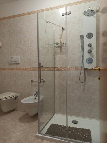 a shower with a glass door in a bathroom at La Scintilla sul Mare in Marina di Montenero
