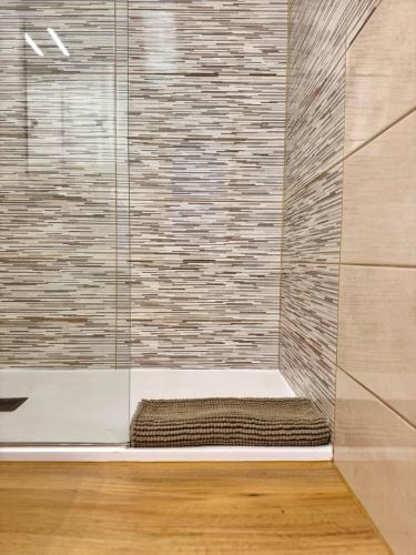 a bathroom with a shower with a glass door at NextGen Casa Ilma in Antigua