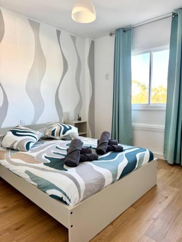 a bedroom with a large bed with blue curtains at NextGen Casa Ilma in Antigua
