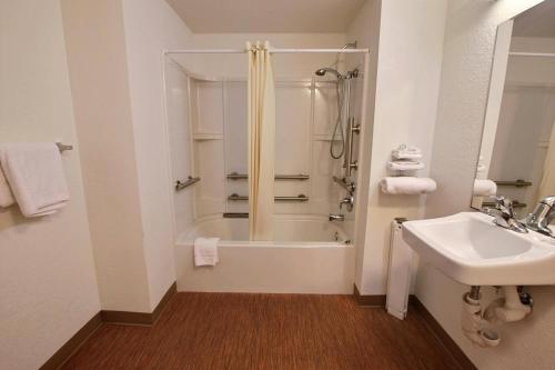 a bathroom with a shower and a sink at Studio 6 Suites Urbana, IL in Urbana