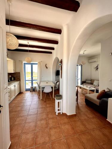 a living room with a table and a couch at Sea View Cycladic Home in Santa Maria