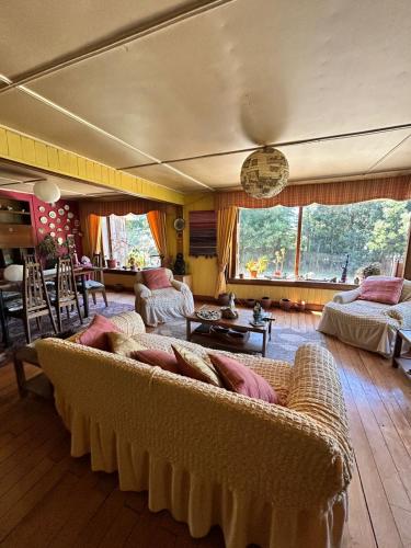 a living room with a couch and a table at Casona de Campo in Puerto Varas
