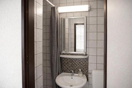 ein Badezimmer mit Waschbecken und Spiegel in der Unterkunft Pension Central Nuernberg-Fuerth in Fürth