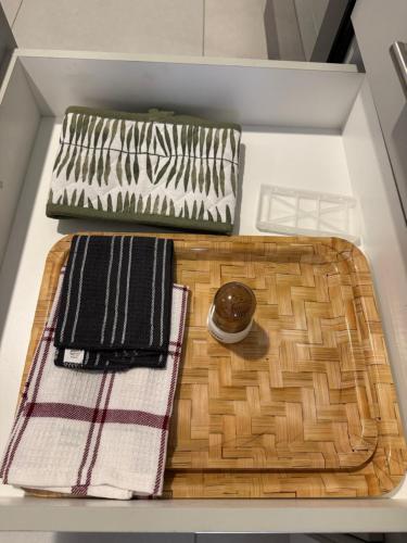 a drawer with two towels and a plate and a table at Habitat Kappa Alexio in Gaborone