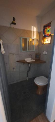 a bathroom with a toilet and a sink at Hospedaje JyH in Paso de los Libres